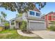Charming two-story home with light gray siding, a gray garage, and a well-manicured lawn at 744 Owl Dr, Louisville, CO 80027