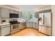 Well-lit kitchen features gray cabinets, stainless steel appliances, and modern backsplash at 744 Owl Dr, Louisville, CO 80027