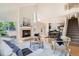 Open-concept living room with fireplace, leading to dining area and staircase at 744 Owl Dr, Louisville, CO 80027