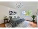 Inviting main bedroom with a chandelier, vaulted ceiling, and a large window at 744 Owl Dr, Louisville, CO 80027