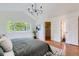 Light-filled main bedroom with large window and view, closet, and bathroom access at 744 Owl Dr, Louisville, CO 80027