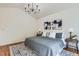 Bright main bedroom featuring a chandelier, hardwood floors, and stylish decor at 744 Owl Dr, Louisville, CO 80027