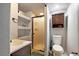 Compact bathroom featuring a glass shower, toilet, and vanity, maximizing space efficiency with its functional design and layout at 3233 W 29Th Ave, Denver, CO 80211