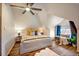 Cozy bedroom with a ceiling fan, complemented by hardwood floors and a seating area, for relaxing and unwinding at 3233 W 29Th Ave, Denver, CO 80211