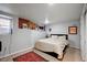Comfortable bedroom with a brick accent wall, featuring plush carpeting and offering a cozy retreat for rest and relaxation at 3233 W 29Th Ave, Denver, CO 80211