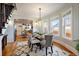 Dining area with hardwood floors, windows, modern lighting, and seating for six at 3233 W 29Th Ave, Denver, CO 80211