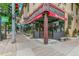 Exterior street view of Mondo Vino with a red awning and outdoor seating area at 3233 W 29Th Ave, Denver, CO 80211