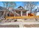 Quaint single-Gathering home featuring a cozy front porch and a well-maintained lawn with a decorative fence at 3233 W 29Th Ave, Denver, CO 80211