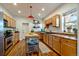 Bright kitchen with light-wood cabinets, an island, and updated appliances at 3233 W 29Th Ave, Denver, CO 80211