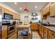 Well-lit kitchen features stainless steel appliances, wood cabinets, and a movable island at 3233 W 29Th Ave, Denver, CO 80211
