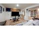Cozy living room with a TV, brick accent wall, and seating area, perfect for entertaining guests or enjoying leisure activities at 3233 W 29Th Ave, Denver, CO 80211