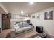 Comfortable living room area with an adjacent kitchenette, featuring plush seating and an open layout for modern living at 3233 W 29Th Ave, Denver, CO 80211