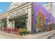 Mead ST Provisions building exterior with a colorful mural, outdoor patio seating and potted plants at 3233 W 29Th Ave, Denver, CO 80211