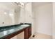 Bathroom featuring an extended dark vanity, modern mirror and fixtures, plus a shower at 3853 Orleans Ct, Denver, CO 80249