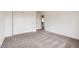 Bright bedroom with adjacent closet and doorway featuring plush carpeting and natural light at 3853 Orleans Ct, Denver, CO 80249