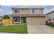 Two-story home featuring a stone facade, tan siding, and a well-manicured lawn at 3853 Orleans Ct, Denver, CO 80249