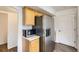Kitchen area showcasing stainless steel refrigerator, microwave, and wooden cabinets at 3853 Orleans Ct, Denver, CO 80249
