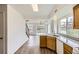 Bright kitchen features wood floors and ample countertop space with natural lighting from a large window at 3853 Orleans Ct, Denver, CO 80249