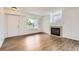 Bright living room with hardwood floors, fireplace, and large window at 3853 Orleans Ct, Denver, CO 80249