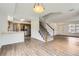Open-concept living space with hardwood floors, staircase, and kitchen view at 3853 Orleans Ct, Denver, CO 80249