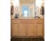 Bathroom vanity with a light wood finish, neutral countertop, and ample storage space at 7472 E 28Th Ave, Denver, CO 80238