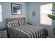 Cozy bedroom with a comfortable bed, side table, and a framed picture on the wall at 7472 E 28Th Ave, Denver, CO 80238