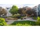 Picturesque community space with lush landscaping, inviting pathways, and charming homes at 7472 E 28Th Ave, Denver, CO 80238