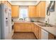 Well-lit kitchen with plenty of cabinets and a view from the window at 7472 E 28Th Ave, Denver, CO 80238
