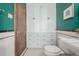 Charming bathroom features a toilet and built in white storage cabinets with drawers and a green wall at 1138 E 14Th Ave # 12, Denver, CO 80218
