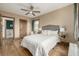 Bedroom showcasing a queen bed, hardwood floors, a ceiling fan, and natural light from the window at 1138 E 14Th Ave # 12, Denver, CO 80218