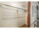 Narrow closet with shelves and rod, white walls and wood-look floor; framed print visible on the wall at 1138 E 14Th Ave # 12, Denver, CO 80218