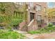 Brick apartment building entrance with climbing vines and a concrete stairway leading to the front door at 1138 E 14Th Ave # 12, Denver, CO 80218