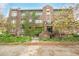 Brick apartment building with ivy-covered walls, set back from the street with a small grassy area at 1138 E 14Th Ave # 12, Denver, CO 80218