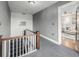 Hallway with stairs, neutral carpet, and doorway to a bright living room, showcasing a clean and inviting space at 1138 E 14Th Ave # 12, Denver, CO 80218