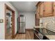 Kitchen with stainless steel fridge, wooden cabinets, granite counters, and hardwood floors at 1138 E 14Th Ave # 12, Denver, CO 80218
