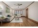 Comfortable living room with hardwood floors, neutral decor, and abundant natural light at 1138 E 14Th Ave # 12, Denver, CO 80218