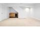 Finished basement area featuring a bar with refrigerator and cabinet storage at 4395 E Jewell Ave # 3, Denver, CO 80222