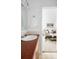 Bathroom featuring a white sink, wood vanity, and a view into the bedroom at 4395 E Jewell Ave # 3, Denver, CO 80222