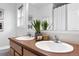 Well-lit bathroom featuring double sinks, modern fixtures, and stylish décor at 4395 E Jewell Ave # 3, Denver, CO 80222