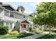 Charming townhome exterior boasts well-manicured lawns, beautiful landscaping, and a bright red front door at 4395 E Jewell Ave # 3, Denver, CO 80222