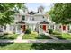 Attractive row of townhomes with manicured lawns, covered porches, and bright red front doors at 4395 E Jewell Ave # 3, Denver, CO 80222