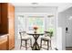 Bright and airy kitchen nook featuring a table with stylish chairs and a large bay window at 4395 E Jewell Ave # 3, Denver, CO 80222