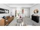 Bright living room featuring stylish furniture, a view of the kitchen, and contemporary decor at 4395 E Jewell Ave # 3, Denver, CO 80222