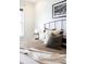 This neutral bedroom features layered pillows, a side table and natural light at 4395 E Jewell Ave # 3, Denver, CO 80222