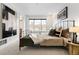 Comfortable bedroom with natural light, stylish decor, and a view to the bath at 4395 E Jewell Ave # 3, Denver, CO 80222