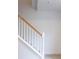 A carpeted staircase with white banisters and wood railing is shown at 4395 E Jewell Ave # 3, Denver, CO 80222