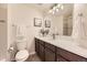 Bathroom featuring a vanity with drawers, a toilet, a sink, and a large mirror at 3578 Tranquility Trl, Castle Rock, CO 80109
