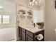 Bright bathroom featuring white quartz countertops, chrome fixtures, floating shelves, and neutral color palette at 3578 Tranquility Trl, Castle Rock, CO 80109