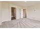 A simple bedroom with grey carpet and two doorways at 3578 Tranquility Trl, Castle Rock, CO 80109