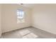 Bright, carpeted bedroom featuring a window with picturesque neighborhood views and natural light at 3578 Tranquility Trl, Castle Rock, CO 80109